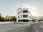 Modernes, weißes Bürogebäude mit geschwungener Fassade an einer ruhigen Straße, umgeben von wenigen Bäumen und weiteren Gebäuden im Hintergrund.